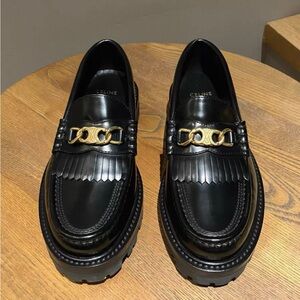 Celine Glossy Black Loafers with Gold Accent